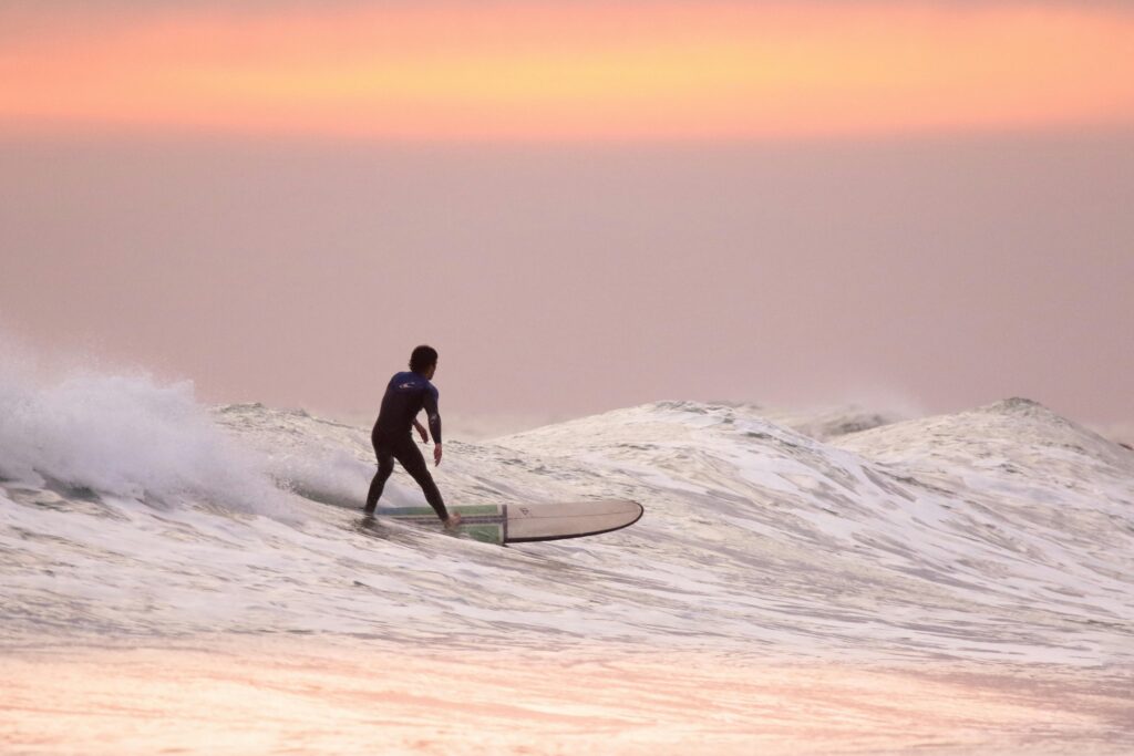 A man surfs in the early morning on one of Hawaii’s beaches.